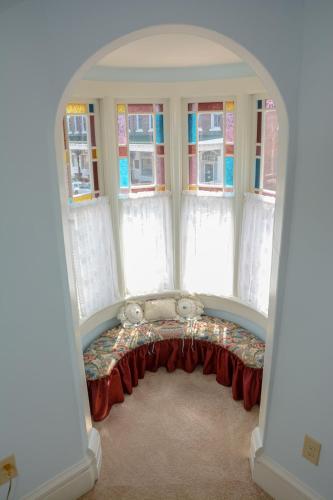 a room with an archway with a couch in front of windows at The Towers Bed & Breakfast in Milford