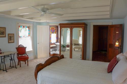 a bedroom with a bed and a table and chairs at The Towers Bed & Breakfast in Milford