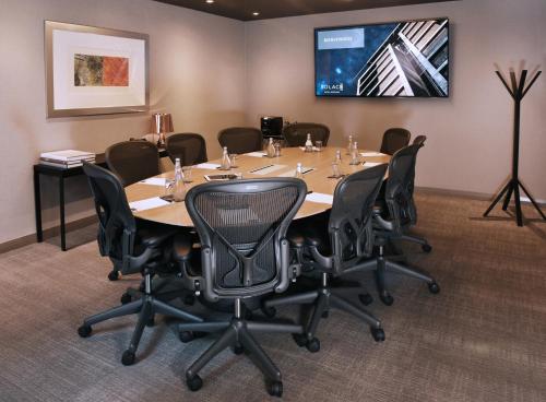 a conference room with a large table and chairs at Solace Hotel Santiago in Santiago