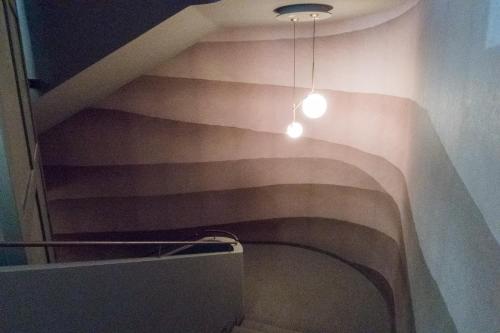 a hallway with a staircase with a light on it at Hotel San Giovanni Roma in Rome
