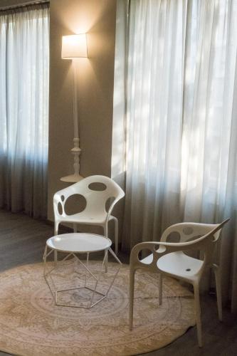 a room with two chairs and a table and a lamp at Hotel San Giovanni Roma in Rome