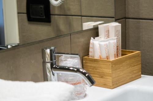 a bathroom counter with a sink with a holder of books at Hotel San Giovanni Roma in Rome