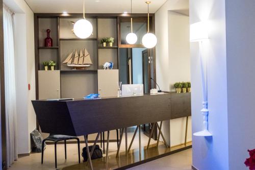 a office with a black desk with a boat on the wall at Hotel San Giovanni Roma in Rome