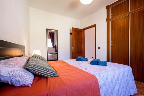 a bedroom with a bed with two towels on it at Orlando 85 in Adeje