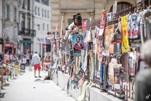 a street with a bunch of signs on a wall at Les Précieuses Suites & Spa I in Avignon