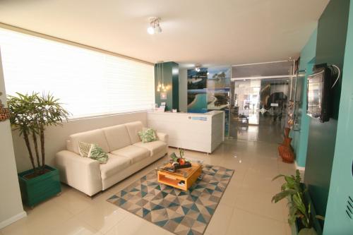 a living room with a couch and a coffee table at Pousada Capital das Águas in Maceió