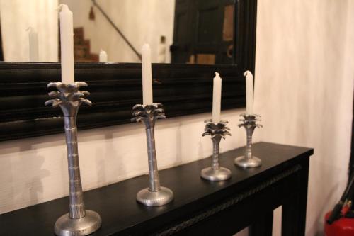 a group of three candlesticks on a table at Riad Terra Bahia in Marrakech