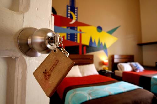 a door with a padlock on it with a bedroom at Hostel Hospedarte Centro in Guadalajara