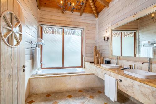 a bathroom with two sinks and a large window at Sanctuary Cap Cana, a Luxury Collection Resort, Dominican Republic, Adult All-Inclusive in Punta Cana