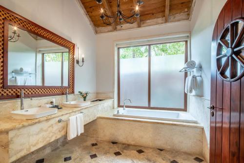 a bathroom with two sinks and a large window at Sanctuary Cap Cana, a Luxury Collection Resort, Dominican Republic, Adult All-Inclusive in Punta Cana
