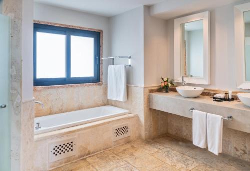 a bathroom with a tub and a sink at Sanctuary Cap Cana, a Luxury Collection Resort, Dominican Republic, Adult All-Inclusive in Punta Cana
