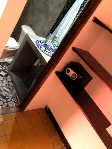 a bathroom with a sink and a door with a camera on it at Hostel Hospedarte Centro in Guadalajara