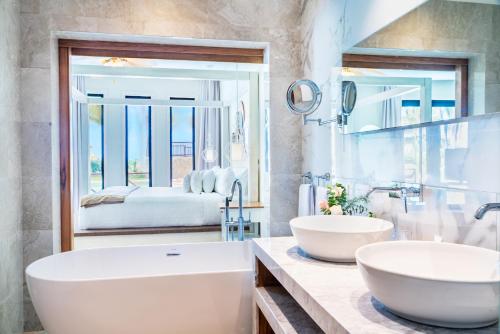 a bathroom with two sinks and a large mirror at Sanctuary Cap Cana, a Luxury Collection Resort, Dominican Republic, Adult All-Inclusive in Punta Cana