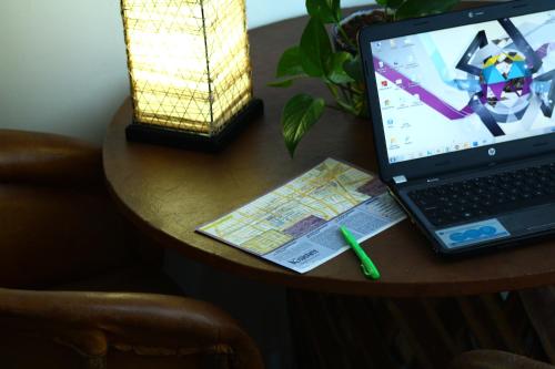 a laptop computer sitting on a table with a map at Hostel Hospedarte Centro in Guadalajara