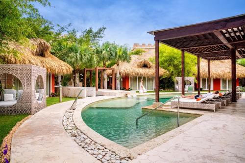 a swimming pool in the middle of a resort at Sanctuary Cap Cana, a Luxury Collection Resort, Dominican Republic, Adult All-Inclusive in Punta Cana