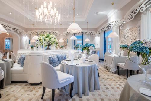 a dining room with tables and chairs and a chandelier at Sanctuary Cap Cana, a Luxury Collection Resort, Dominican Republic, Adult All-Inclusive in Punta Cana
