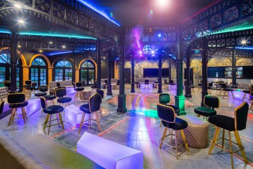 a room with tables and chairs in a building with lights at Sanctuary Cap Cana, a Luxury Collection Resort, Dominican Republic, Adult All-Inclusive in Punta Cana