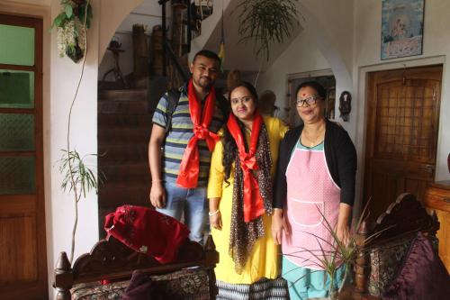 a group of three people standing in a room at Mansarover Home Stay in Kalimpong