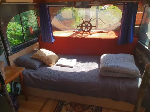 a small bed in the back of an rv at Wild Days Accommodation in Palm Beach