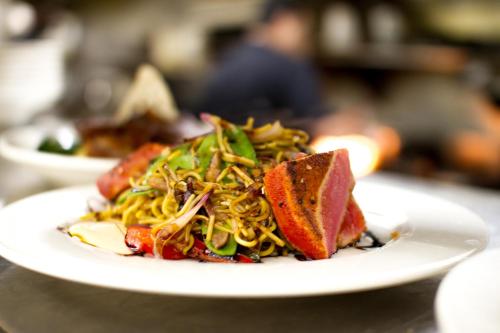 a plate of food with noodles on a table at Mirabeau Park Hotel in Spokane Valley