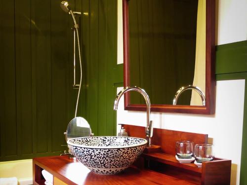 a bathroom with a sink and a mirror at Maison Houng Chanh - Luang prabang in Luang Prabang