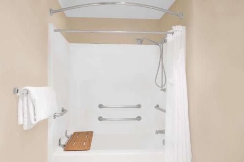 a bathroom with a shower with a shower curtain at Baymont by Wyndham Litchfield in Litchfield