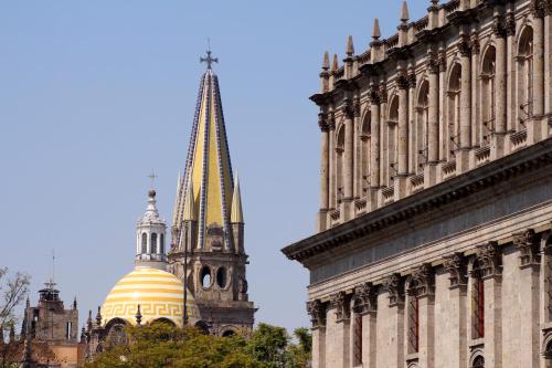 a building with a yellow dome and a tower at Hostel Hospedarte Centro in Guadalajara