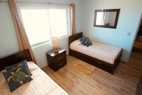 Cama o camas de una habitación en Maz4you Beachfront Condo