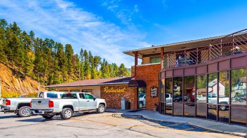 a white truck parked in front of a building at Deadwood Miners Hotel & Restaurant in Deadwood