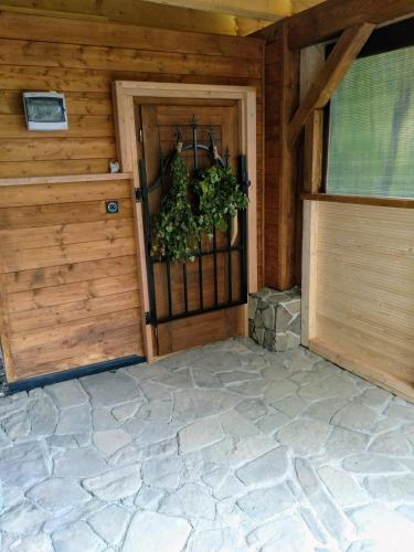 a garage with a door with a plant on it at U ponocného pod Ondřejníkem in Frýdlant nad Ostravicí