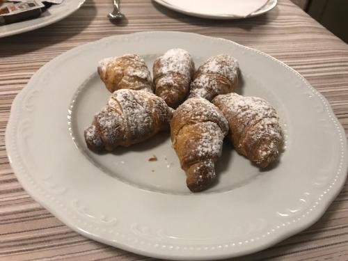 a white plate with powdered pastries on a table at Villa D'Anzi B&B in Ginosa