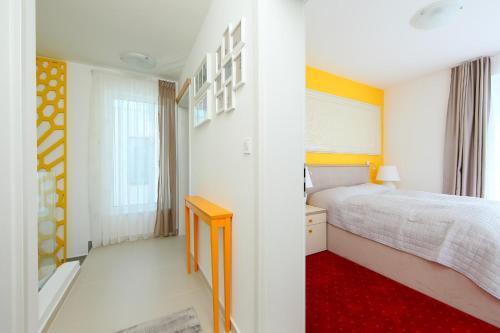 a bedroom with a bed and a red rug at Gorazd Nyaralóház in Balatonfüred