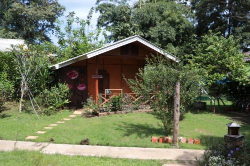 a small house with a garden in front of it at Chiang Dao Story Camp in Chiang Dao