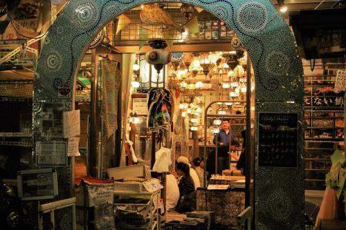 a shop with an arched doorway and people in a store at Alo BnB 2 - Near NIPPORI, SENDAGI, YANAKA GINZA - Self check-in in Tokyo