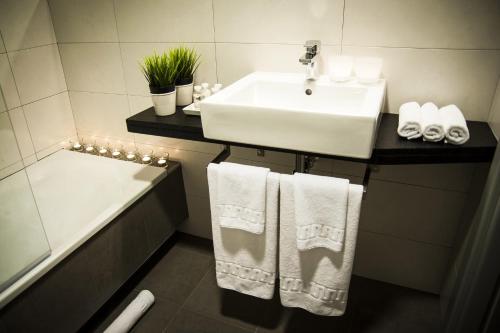 a bathroom with a white towel hanging on the wall at Hotel Forum Evolución in Burgos