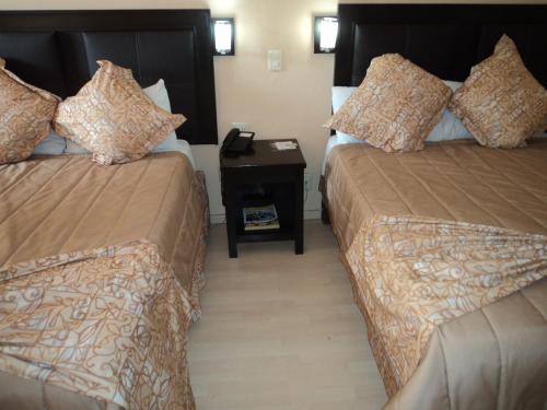 Postel nebo postele na pokoji v ubytování Hotel Santa Cruz Mochis