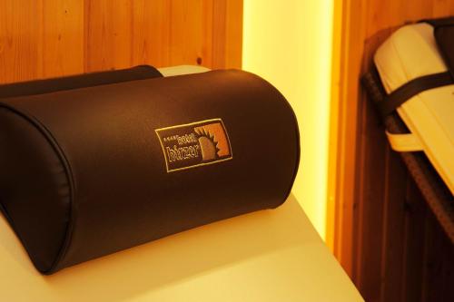 a black suitcase sitting on top of a bed at Hotel Hirzer ***S in Saltusio