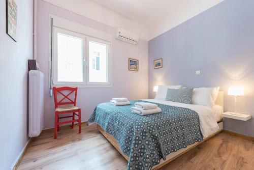 アテネにあるSuite Dreams Near Acropolis!のベッドルーム1室(ベッド1台、赤い椅子付)