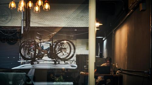 a bike hanging from a ceiling in a room at MILU Backpacker Hostel in Puli