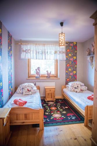 a bedroom with two beds and a window at Rezydencja Sąsiadów Zakopanego in Zakopane