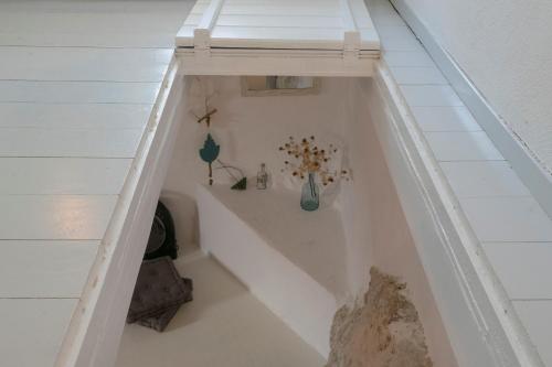 a bath tub with vases and flowers in a room at moonhouse in Skiathos