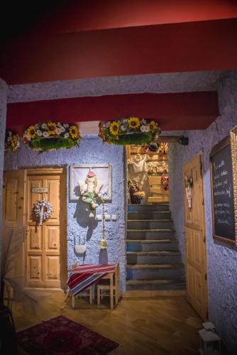 a room with stairs and a door with flowers on the wall at Rezydencja Sąsiadów Zakopanego in Zakopane