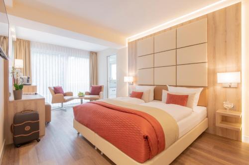 a bedroom with a large bed in a room at Hotel Wegner - T h e culinary art hotel in Hannover