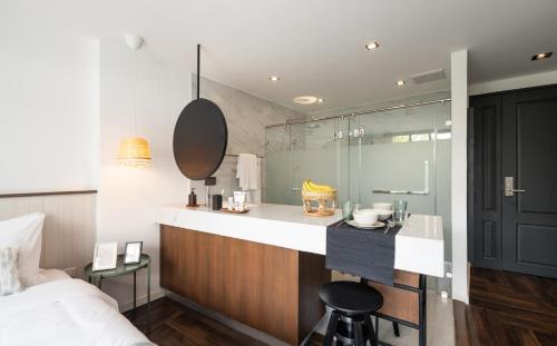 a bathroom with a sink and a shower in a room at Warm Window Silom in Bangkok