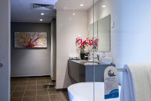 a bathroom with a sink and a toilet in a room at Radisson Blu Mammy Yoko Hotel in Freetown