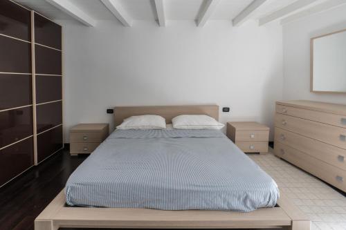 バーリにあるREM Apartment - Moscatelliのベッドルーム(大型ベッド1台、木製キャビネット付)