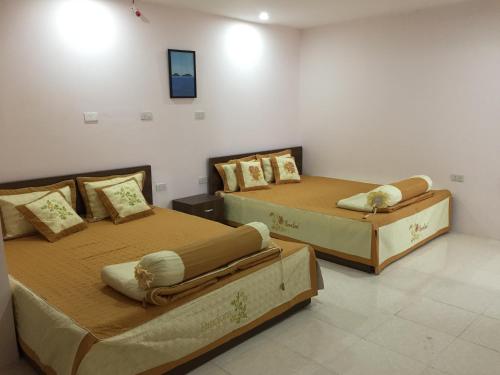 two beds sitting next to each other in a room at B Stay Hotel in Phu Quoc