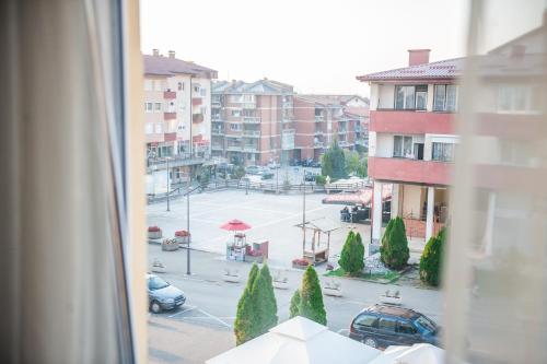 a view of a city street from a window at Prenoćište "NACIONAL" in Prnjavor