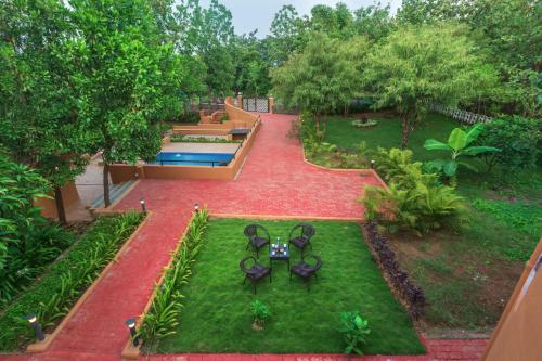 an aerial view of a garden with tables and chairs at SaffronStays Ekaant, Vikramgad - party-perfect pool villa with spacious lawn in Pālghar