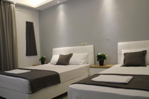Postel nebo postele na pokoji v ubytování Zeus Hotel